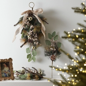 Nordic Christmas wreath with pine needles, cones, and golden ornaments for wall decor