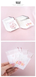 Close-up of pink self-adhesive bags with Sweet Time heart prints for cookies and candy