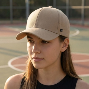 Men's khaki cotton baseball cap with side logo, worn by a model in a sunny outdoor setting