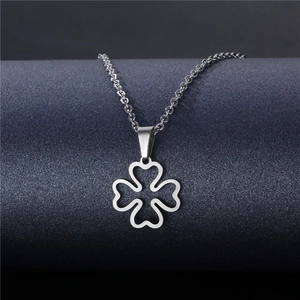 Minimalist silver stainless steel hollow four-leaf clover necklace on dark blue display
