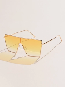 Detail of square oversized metal sunglasses with yellow gradient lenses and slim frame