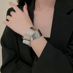Detail of silver multi-layer metal cuff bracelet with high-polish finish on model