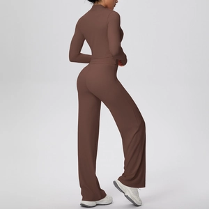 Detail view of coffee-colored yoga set featuring high-waist trousers and mock neck top