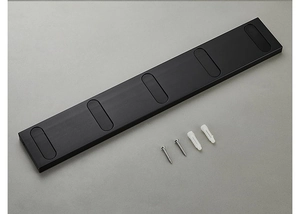Close-up of black folding coat hook with mounting screws and plastic wall anchors