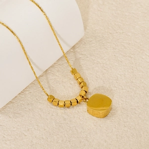 Classic 18K gold-plated stainless steel smile necklace with square beads on cream background