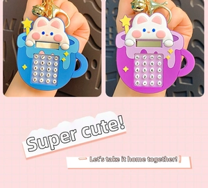 Macro shot of mini cartoon rabbit calculator keychain in blue and purple silicone