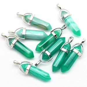 Macro shot of green quartz hexagonal prism pendants with metallic bail attachments