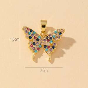 Macro detail of gold butterfly pendant with colorful zircons, size 1.8cm by 2cm