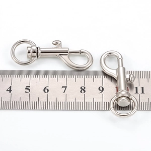 Set of silver metal spring swivel snap hooks for bags and keychains with ruler for scale