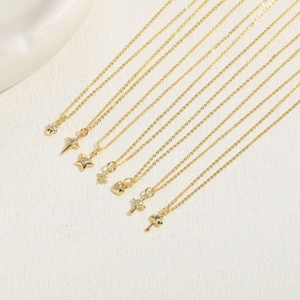 Detailed display of assorted gold necklaces with star heart and cross crystal pendants