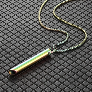 Macro shot of colorful rainbow stainless steel cylinder meditation pendant with box chain