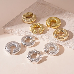 Metallic C-shaped ear cuffs in gold and silver finish with textured twisting design
