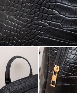Detailed macro view of black crocodile pattern PU leather texture and premium gold zippers
