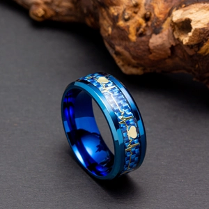 Macro shot of blue carbon fiber inlay with gold ECG heartbeat pattern on titanium steel ring