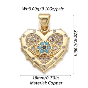 Detailed view of a gold heart pendant with evil eye and measurements on white background