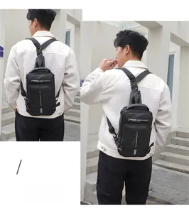 Detail showing adjustable buckle strap and multi-compartment design on black sling bag
