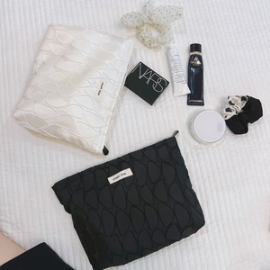Quilted cosmetic bag set in black and white with simple wish label and floral pattern