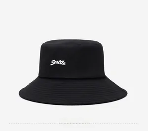 Side view of black cotton bucket hat featuring white Seattle embroidery in detail