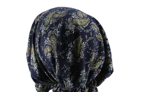 Close-up of navy blue paisley turban hat with soft pleated fabric and floral pattern