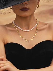 Detail of freshwater pearl necklace with gold fan pendants and matching hoop earrings