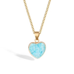 Detailed view of heart-shaped blue crystal pendant with gold-plated link chain