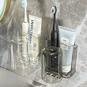 Detail of wall-mounted toothpaste and toothbrush holder set with two cups for bathroom