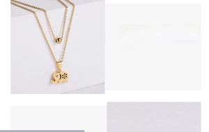 Close-up of gold-plated elephant pendant with white rhinestones on double-layer chain