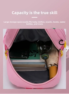 Detail showing high-capacity interior of pink kids backpack with books and water bottle