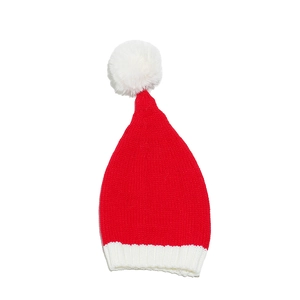 Close-up of a red and white Christmas knit hat with a fluffy white pom-pom and ribbed edge