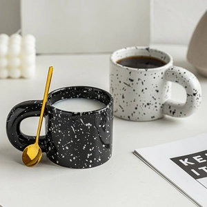 Ceramic splash ink mugs with fat handles in black and white styles with gold spoon