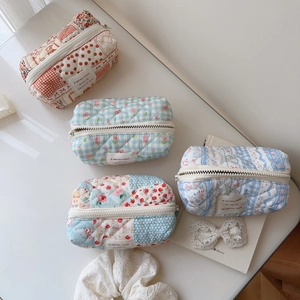 Quilted floral and checkered cotton makeup bag with a zipper and soft padded texture