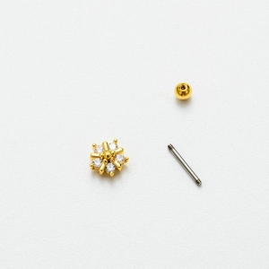 Macro detail of disassembled stainless steel stud earring with zircon flower and screw back
