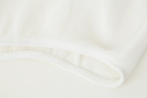 Macro shot of breathable white mesh fabric with high-quality stitching and fine texture