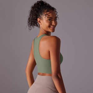 Detail of racerback sports bra and high-waisted leggings in avocado green and lilac