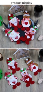 Detail of Christmas cutlery holders featuring Santa and snowman embroidery on red felt