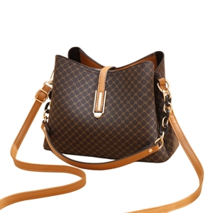 Brown and beige geometric print bucket bag with adjustable shoulder strap and metal hardware