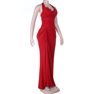 Detail of red halter neck dress featuring lace trim and elegant pleated draping