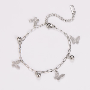 Detail of silver stainless steel bracelet featuring matte butterfly charms and beads