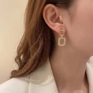 Elegant gold geometric double-loop earrings with shimmering pavé cubic zirconia