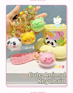 Detail of cute acrylic animal head keychains with panda pig and frog charms