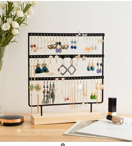 Three-tier black metal earring organizer with sturdy rectangular wooden base