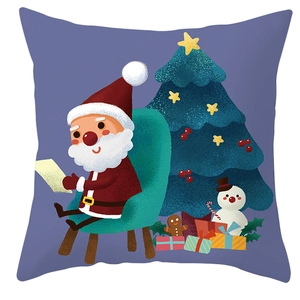 Detail of Christmas pillow cover with Santa reading by a festive tree on blue background