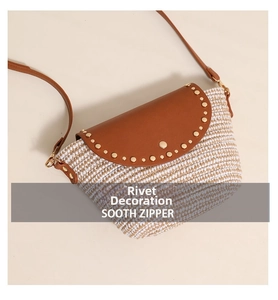 Macro detail of the woven straw texture and brown leather flap with gold rivet studs
