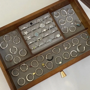Silver geometric hollow wave rings and elegant jewelry set in a luxury display case