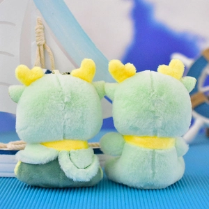 Back view of cute green plush dragon keychains with yellow heart horns and scarves