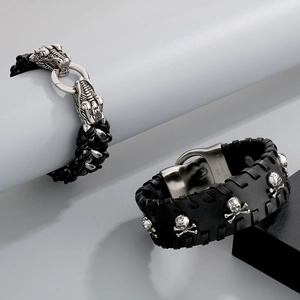 Macro detail of men's punk bracelet set with dragon head and skull charms in 316L steel
