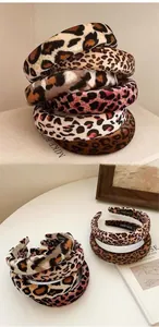 Close-up of thick leopard print velvet headbands with handmade labels and sponge padding