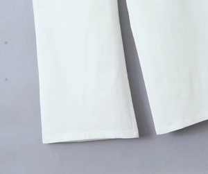 Detail of straight leg hem and stitching on white low-waisted cargo pants for women