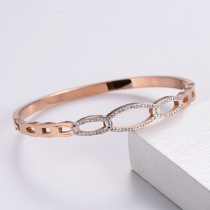 Macro detail of rose gold hollow oval bracelet with micro-pave sparkling crystals