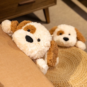 Close-up of soft brown and white plush prone dog toy with fluffy fur texture.
